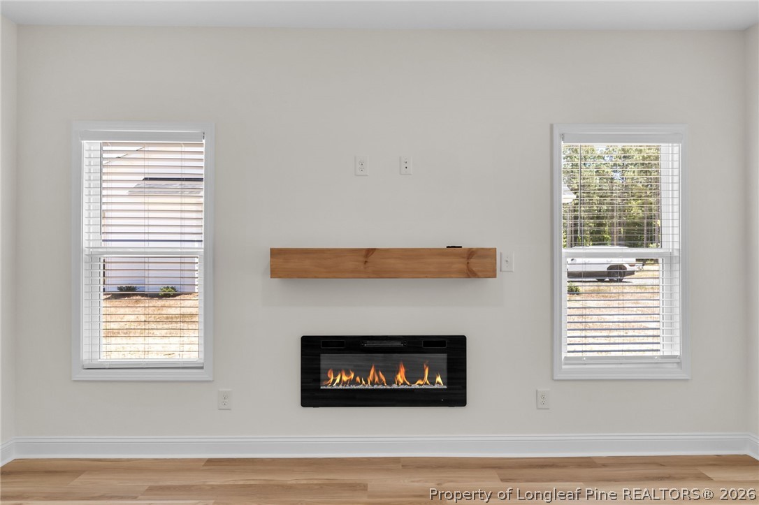131 Merle Road Pinebluff, NC 28373 - Photo 9 of 33 a living room with a fireplace and a window