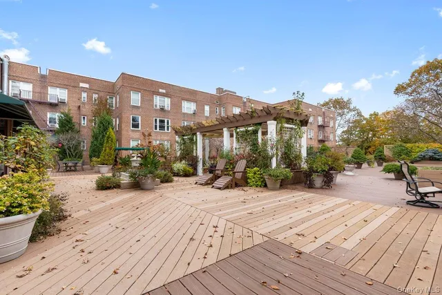 a view of a building with sitting area and furniture