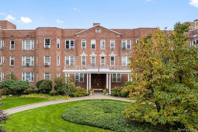 a view of a street with potted plants