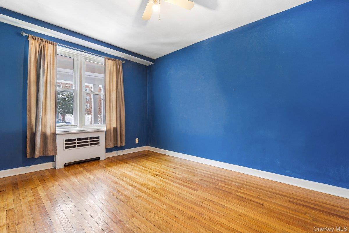 2 Overlook Road, Unit 1B7A White Plains, NY 10605 - Photo 7 of 18 a view of an empty room with a window and wooden floor