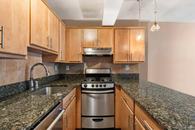 a view of kitchen with wooden floor and electronic appliances
