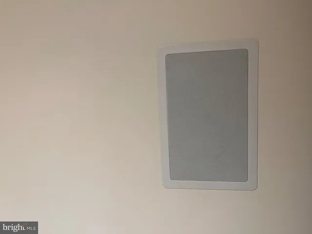 a bathroom with a granite countertop toilet and a sink