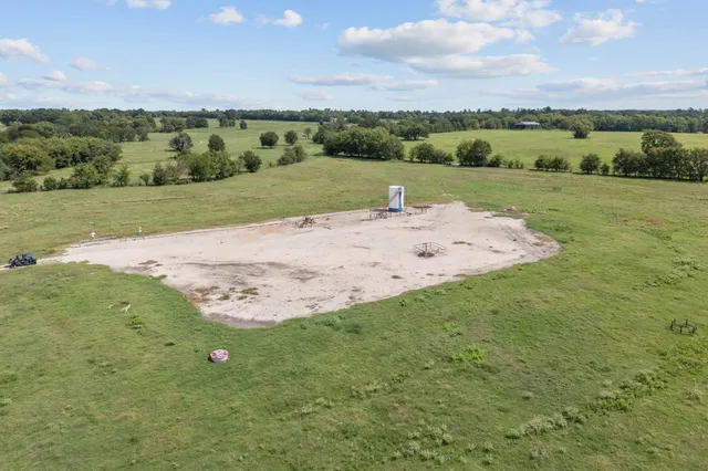 a view of a field with an ocean