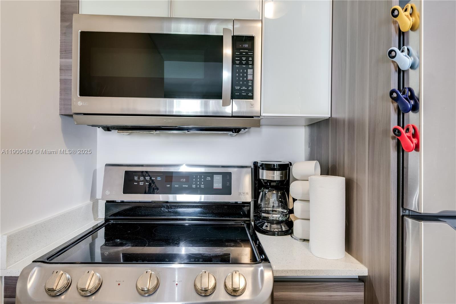 481 Northeast 29th Street, Unit 601 Miami, FL 33137 - Photo 11 of 23 a kitchen with a stove and a microwave