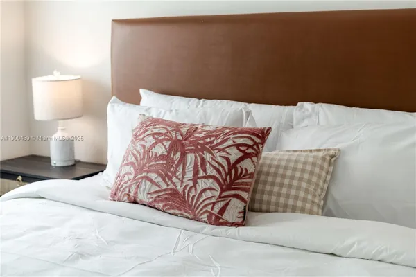 a bedroom with a bed and lamp