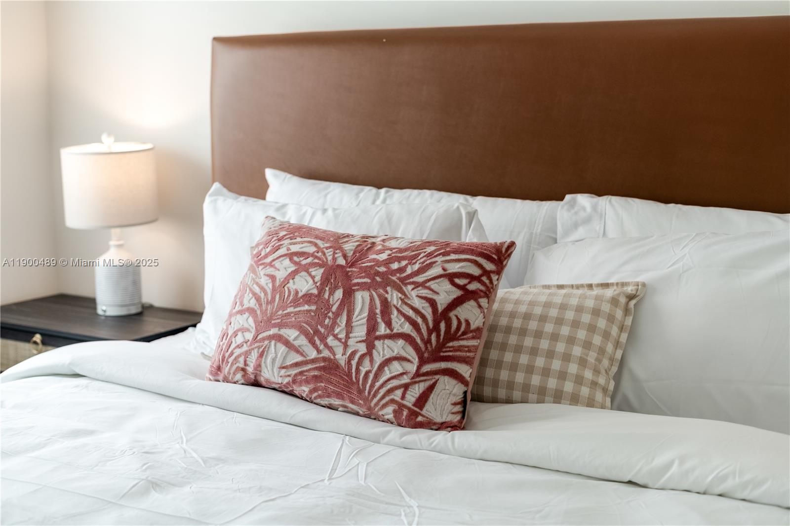 481 Northeast 29th Street, Unit 601 Miami, FL 33137 - Photo 13 of 23 a bedroom with a bed and lamp