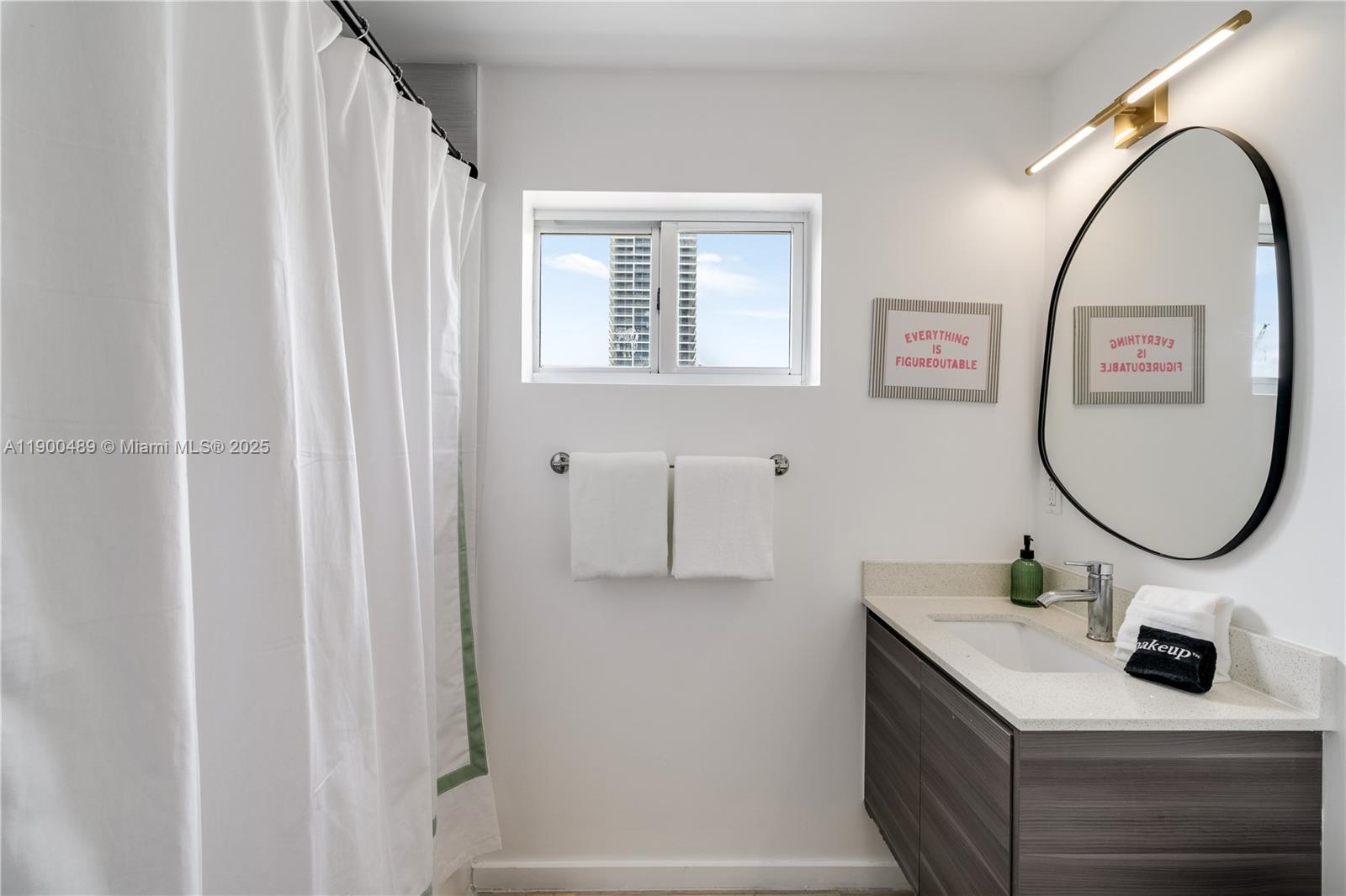 481 Northeast 29th Street, Unit 601 Miami, FL 33137 - Photo 15 of 23 a bathroom with a sink and a mirror