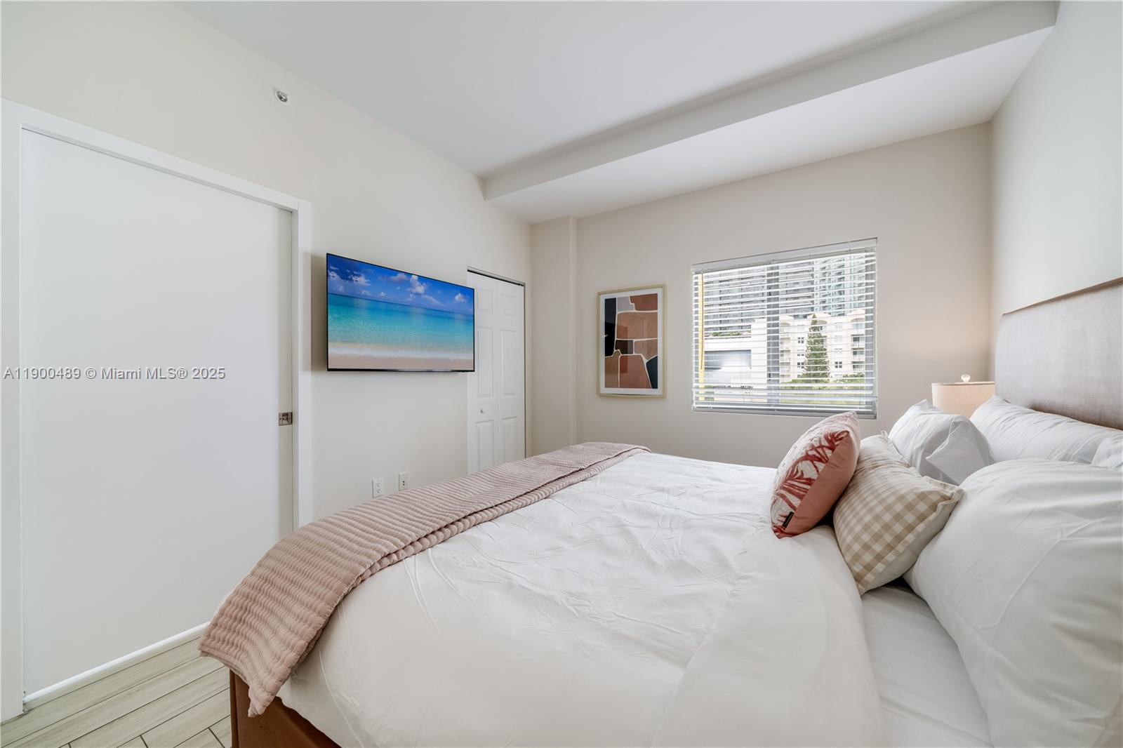 481 Northeast 29th Street, Unit 601 Miami, FL 33137 - Photo 16 of 23 a bedroom with a bed and a window