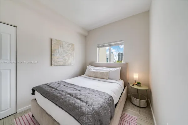 a bedroom with a bed and window