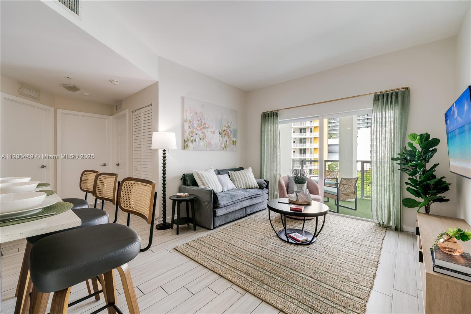 481 Northeast 29th Street, Unit 601 Miami, FL 33137 - Photo 2 of 23 a living room with furniture and a potted plant