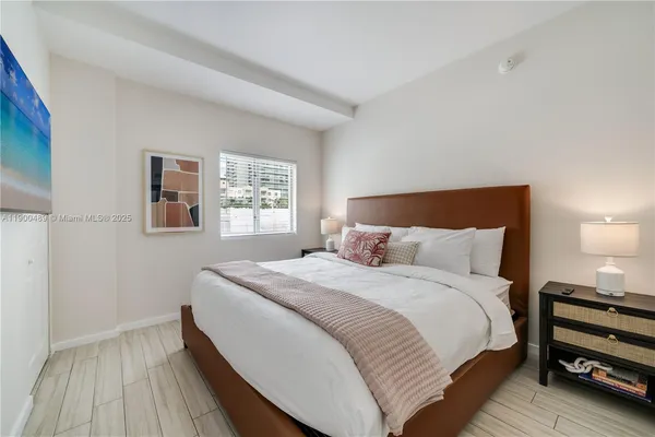 a bedroom with a bed and a night stand