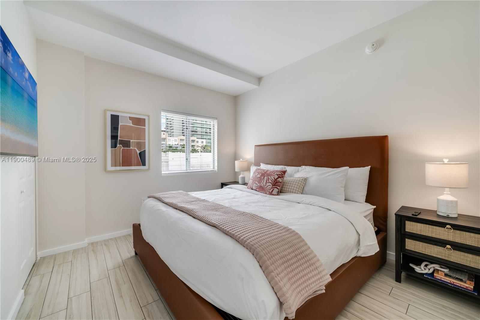 481 Northeast 29th Street, Unit 601 Miami, FL 33137 - Photo 4 of 23 a bedroom with a bed and a night stand
