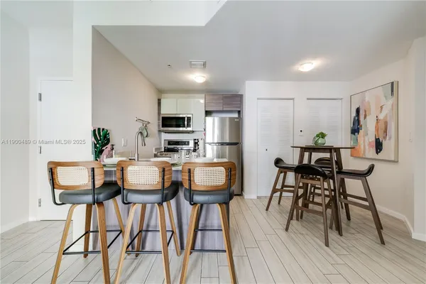a view of a dining room with furniture and wooden floor