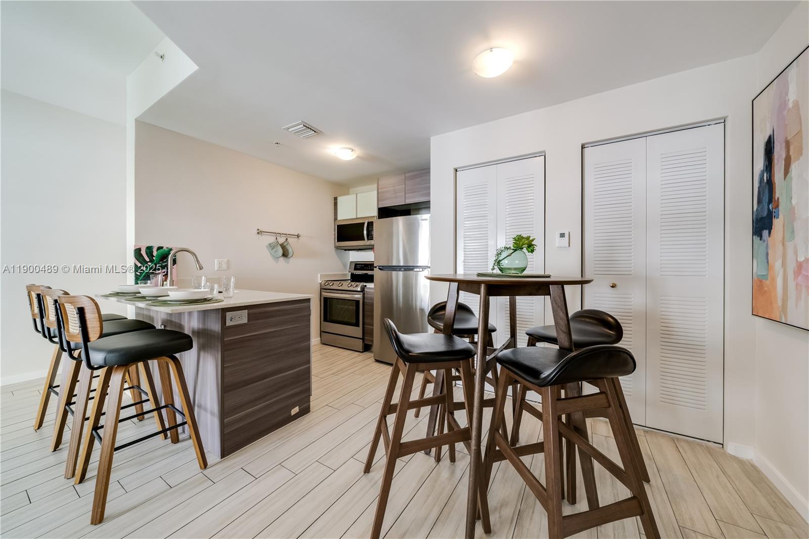 481 Northeast 29th Street, Unit 601 Miami, FL 33137 - Photo 9 of 23 a view of a dining room with furniture and wooden floor