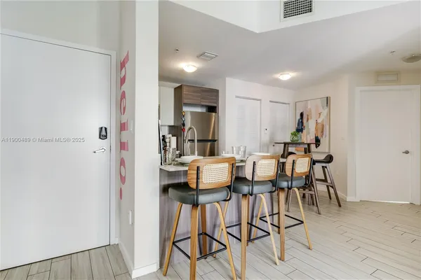 a dining room with furniture and wooden floor