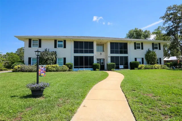 a front view of a house with a yard and porch