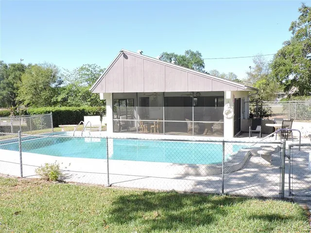 a view of an house with backyard space and balcony