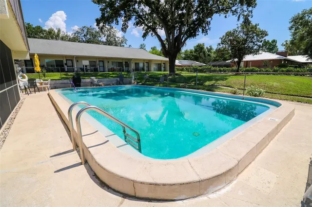 a kitchen with stainless steel appliances granite countertop a refrigerator a sink a stove and a refrigerator