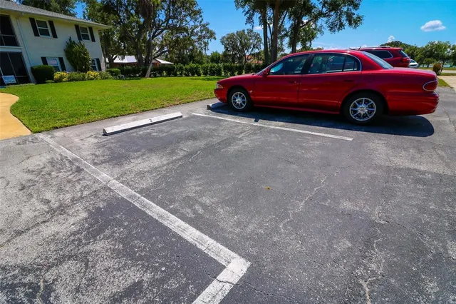 an aerial view of a house with a yard and lake view