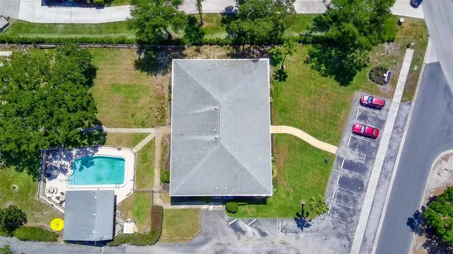 an aerial view of residential house with outdoor space and trees all around