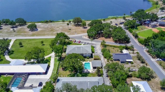 an aerial view of residential house with outdoor space and swimming pool