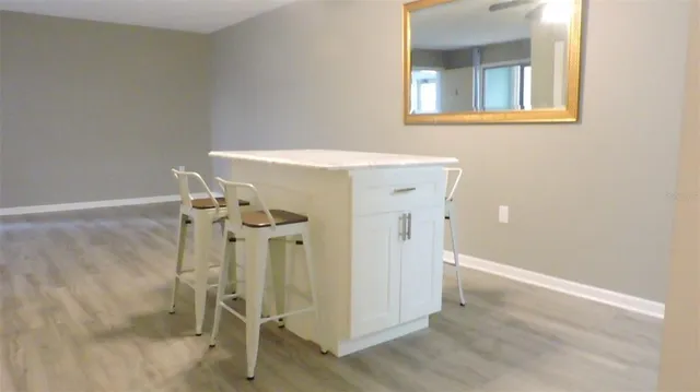 a dining room with furniture a chandelier and wooden floor