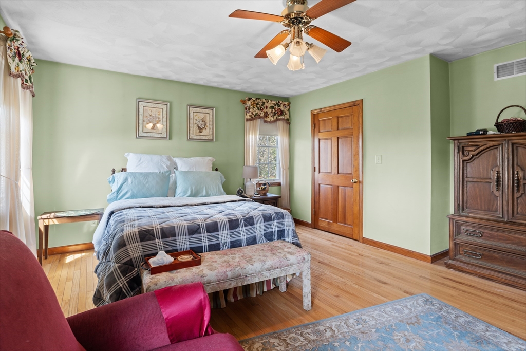 36 High Street Freetown, MA 02702 - Photo 27 of 42 a bedroom with a bed and wooden floor