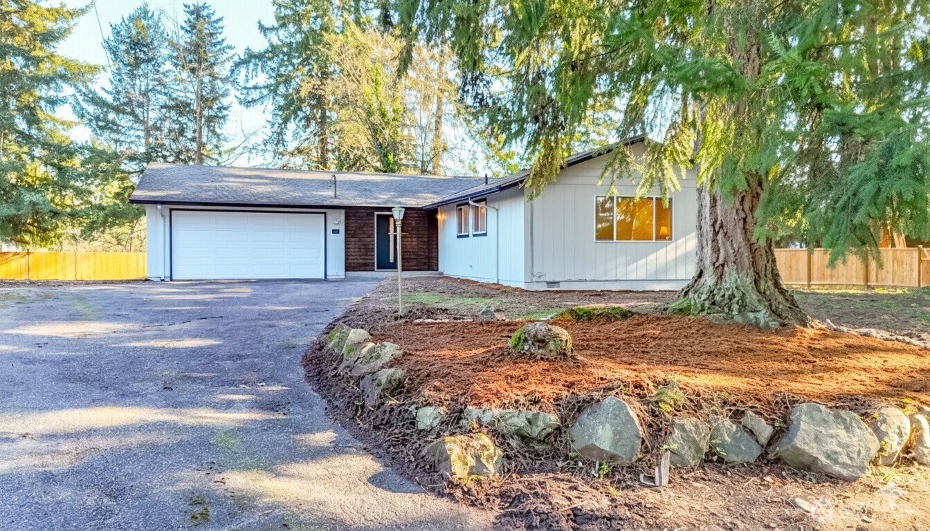 a front view of a house with a yard and garage