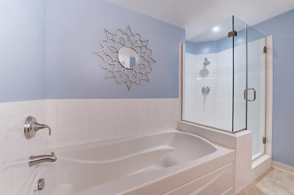 a bathroom with a granite countertop double vanity sink mirror and toilet
