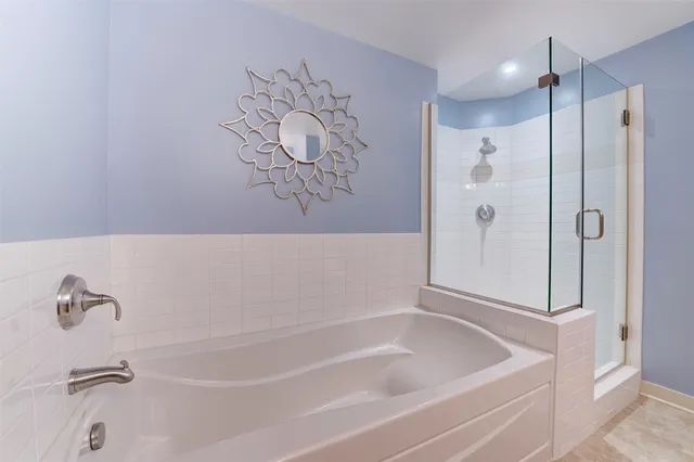 a bathroom with a granite countertop double vanity sink mirror and toilet