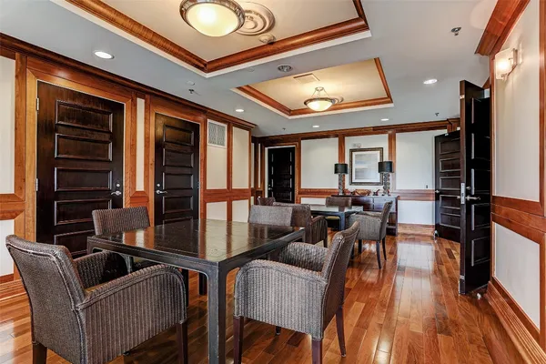 a dining room with furniture and wooden floor