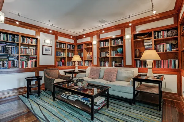 a living room with furniture and a book shelf