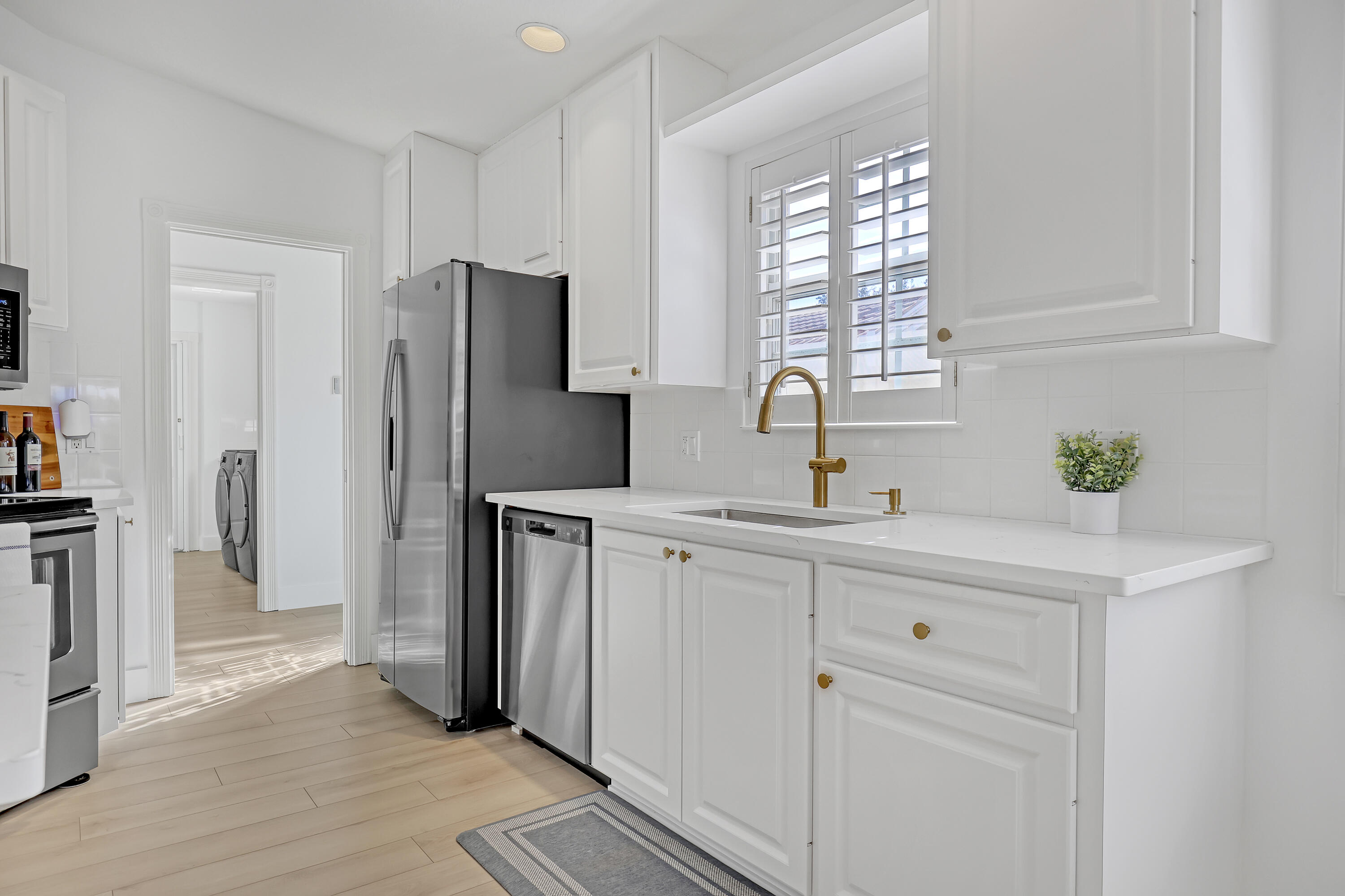 907 Southwest Balmoral Trace Stuart, FL 34997 - Photo 12 of 46 a kitchen with stainless steel appliances white cabinets and a sink