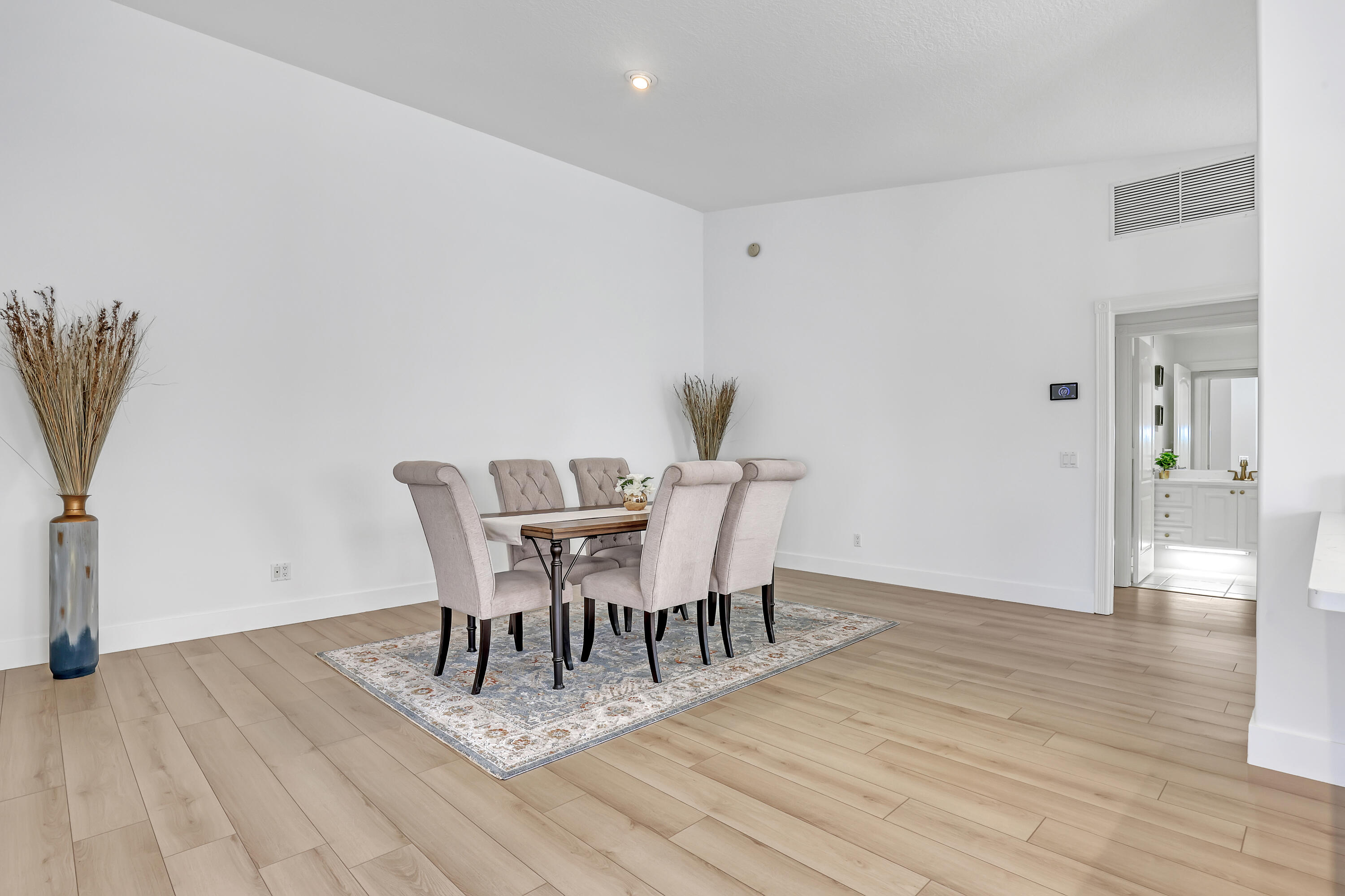 907 Southwest Balmoral Trace Stuart, FL 34997 - Photo 16 of 46 a view of a dining room with furniture and wooden floor