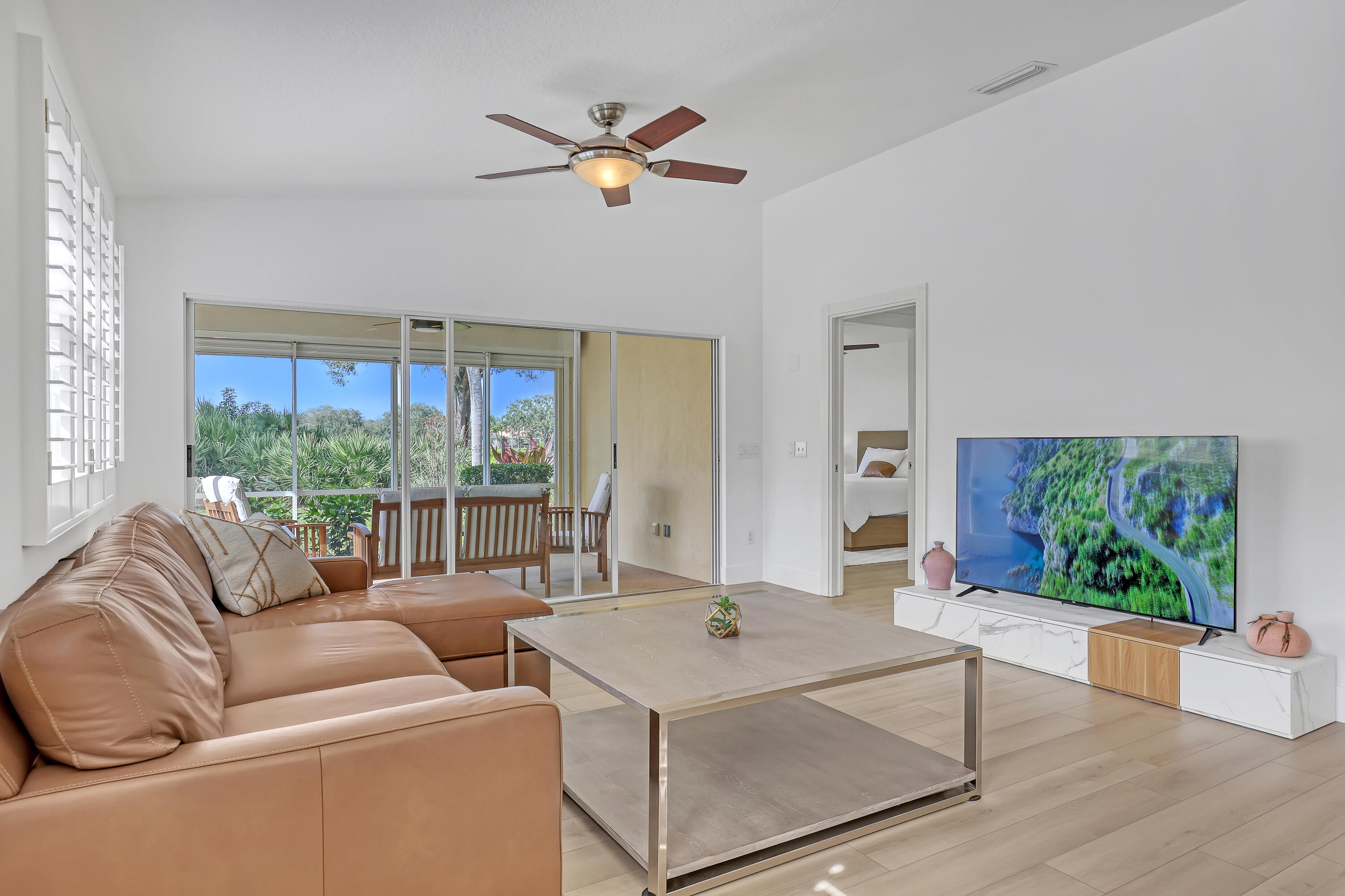 907 Southwest Balmoral Trace Stuart, FL 34997 - Photo 2 of 46 a living room with furniture and a large window