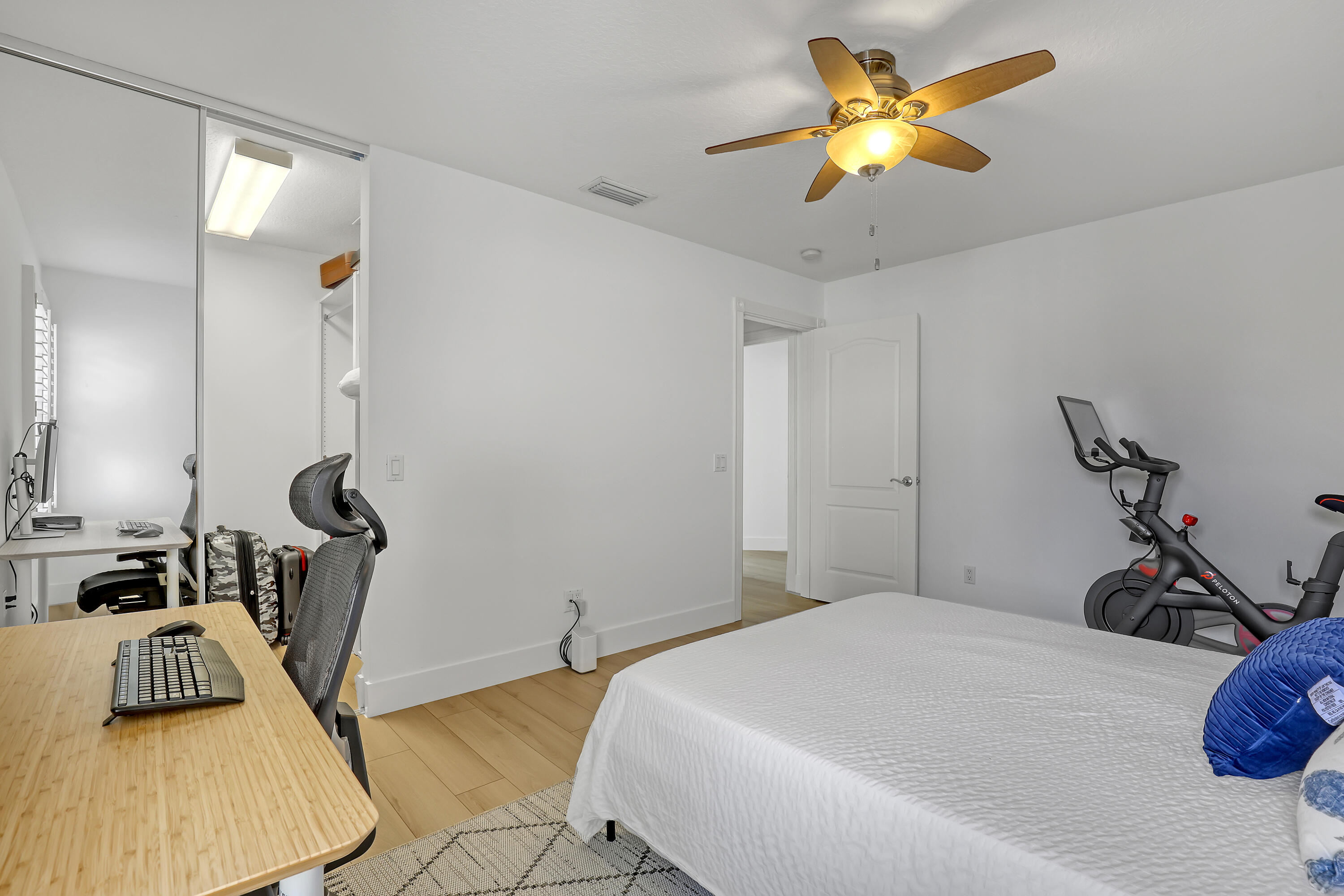 907 Southwest Balmoral Trace Stuart, FL 34997 - Photo 22 of 46 a bedroom with a bed and a chandelier