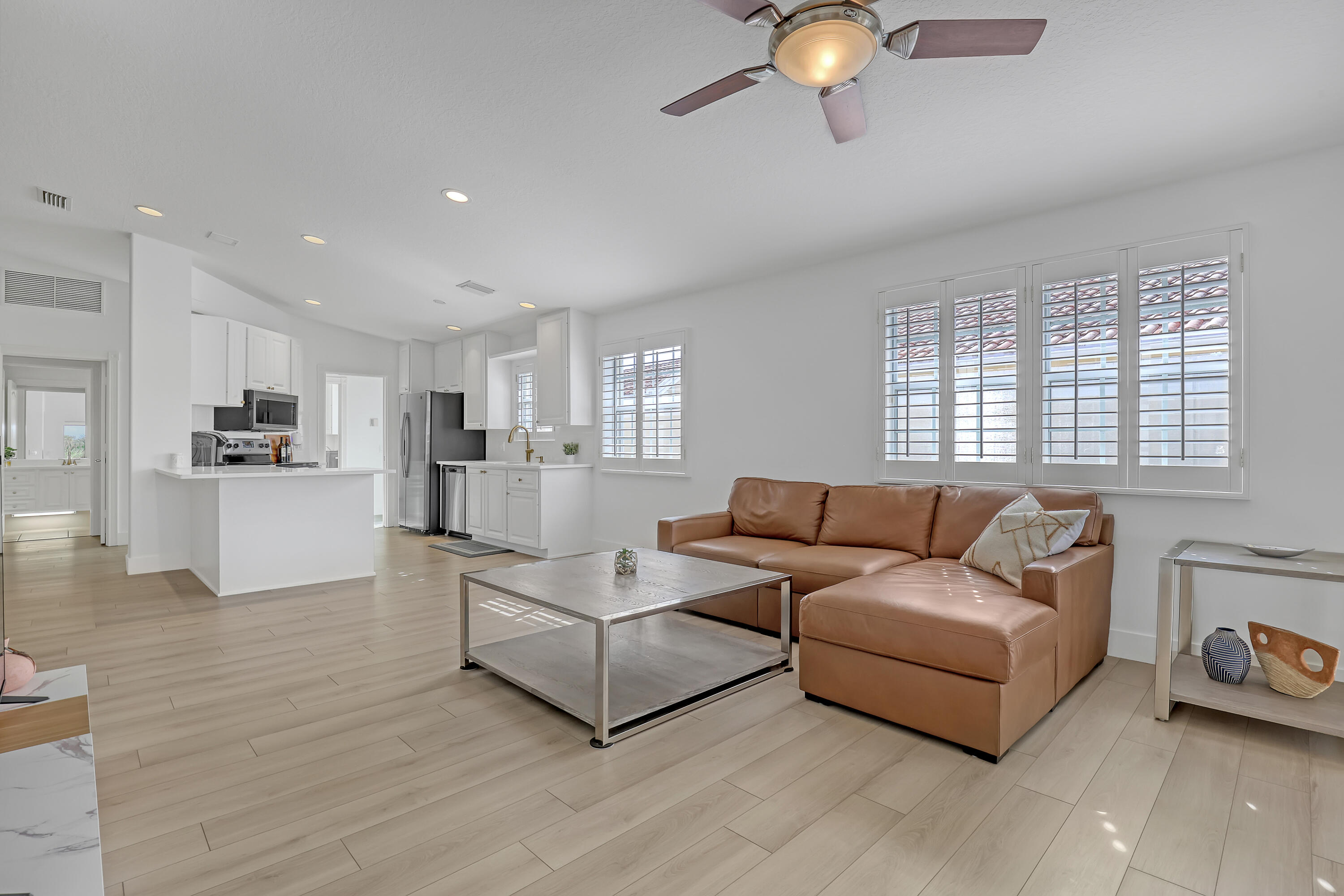 907 Southwest Balmoral Trace Stuart, FL 34997 - Photo 3 of 46 a living room with furniture and kitchen view