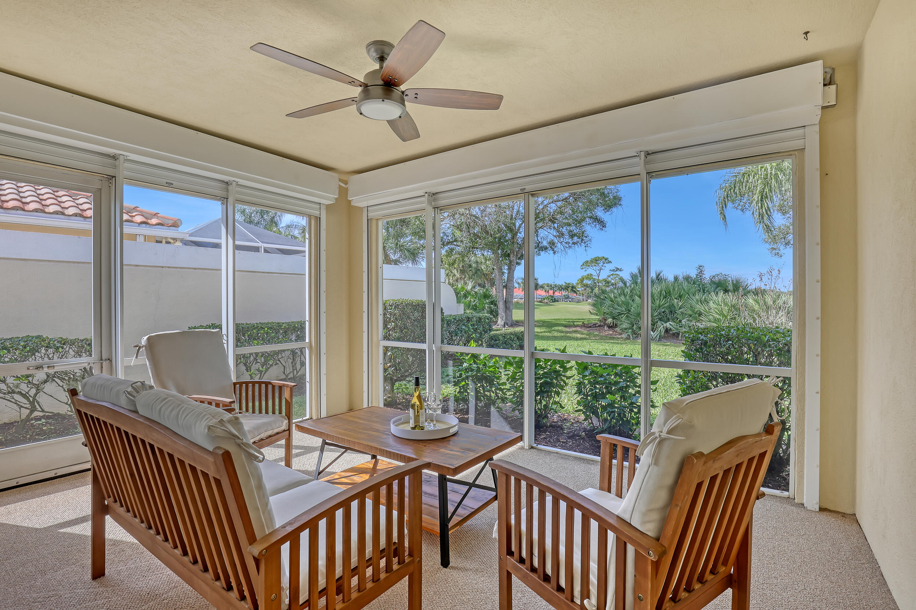 907 Southwest Balmoral Trace Stuart, FL 34997 - Photo 4 of 46 a dining room with furniture large windows and wooden floor