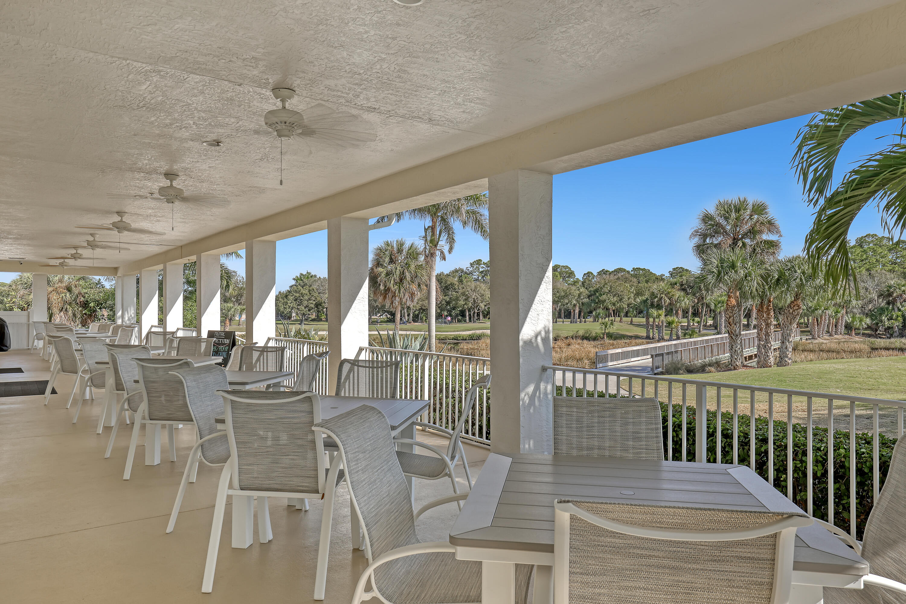 907 Southwest Balmoral Trace Stuart, FL 34997 - Photo 44 of 46 a view of a dining room with furniture wooden floor and chandelier