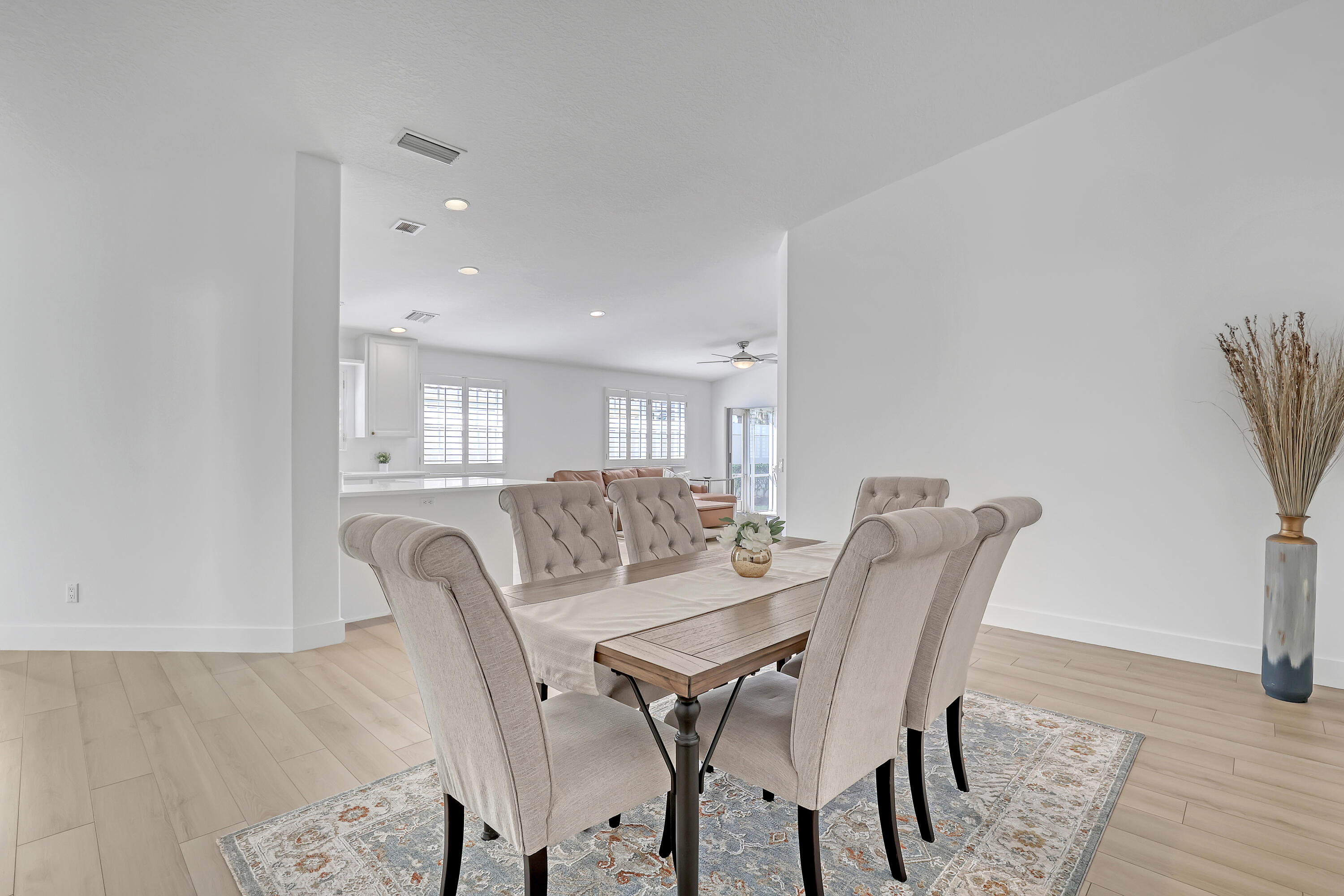 907 Southwest Balmoral Trace Stuart, FL 34997 - Photo 6 of 46 a view of a dining room with furniture and wooden floor