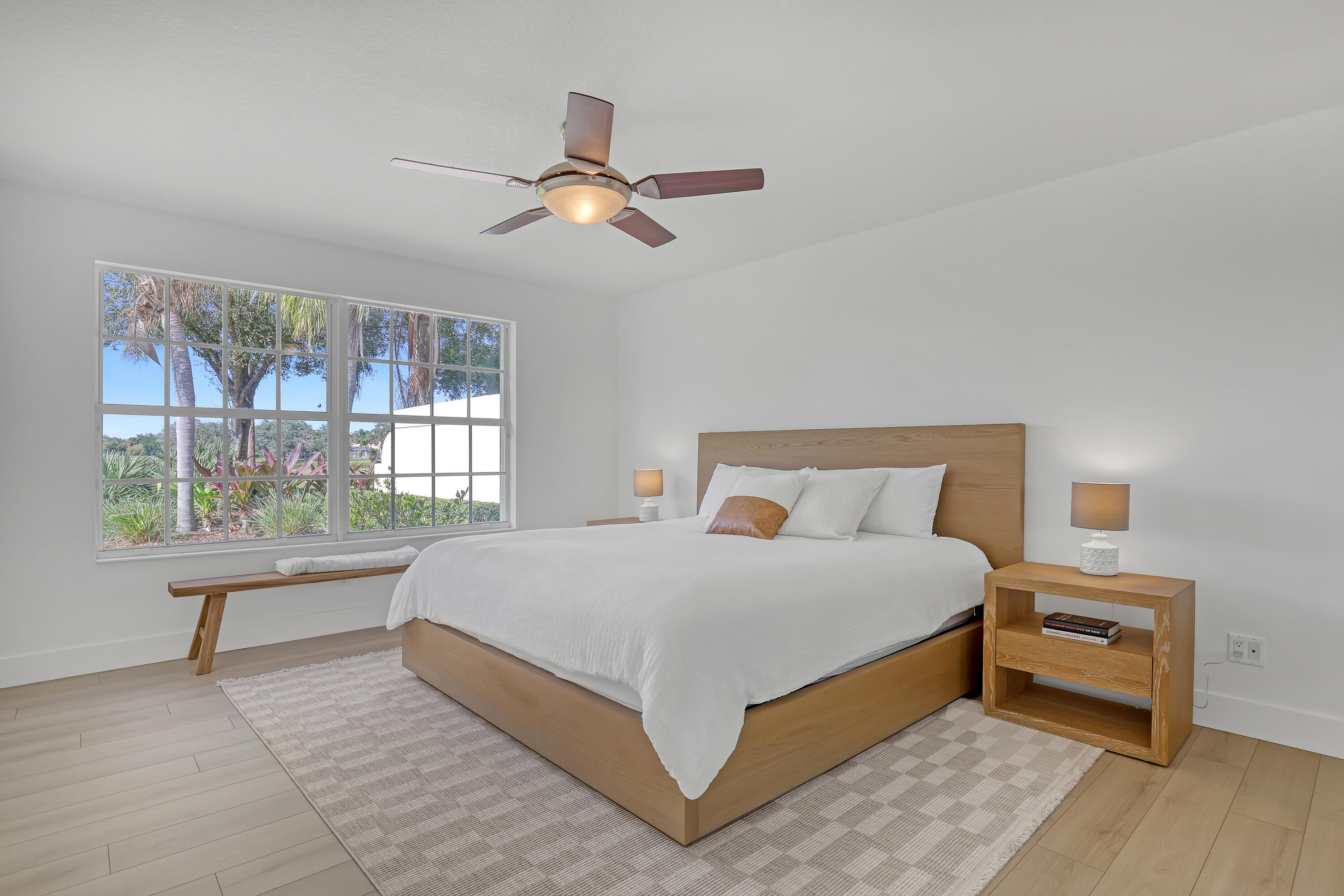 907 Southwest Balmoral Trace Stuart, FL 34997 - Photo 7 of 46 a large bed sitting in a bedroom next to a window