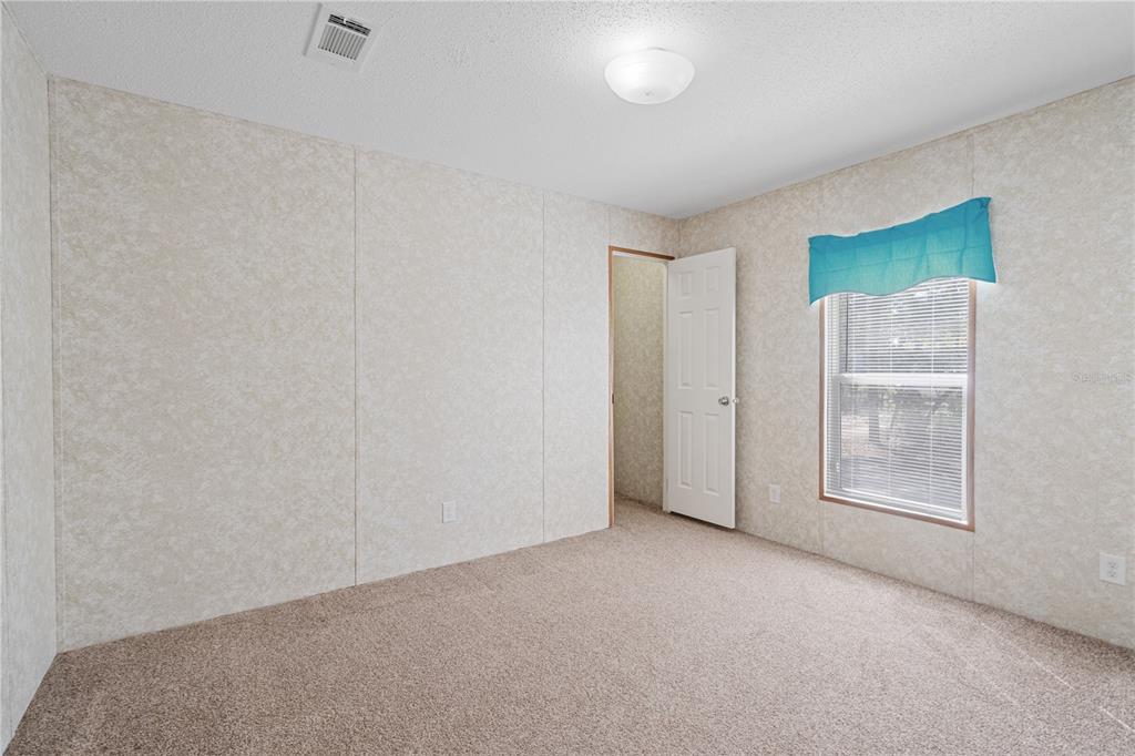 10811 Northeast 57th Street Bronson, FL 32621 - Photo 11 of 21 an empty room with windows and closet