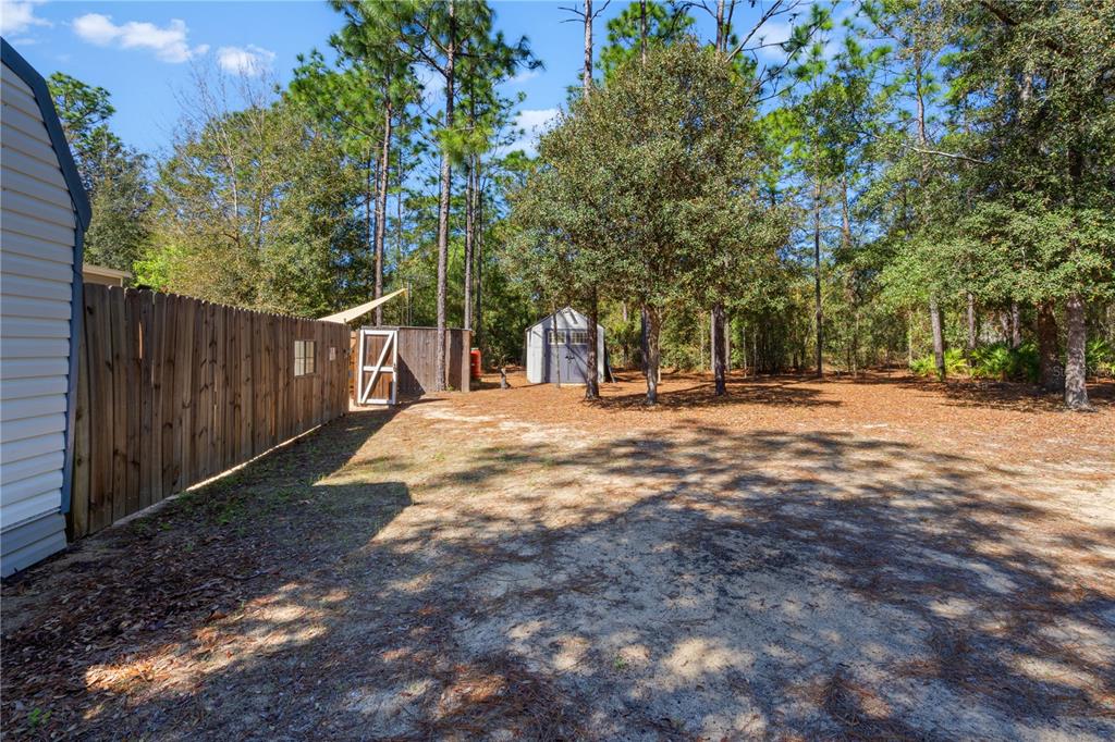 10811 Northeast 57th Street Bronson, FL 32621 - Photo 20 of 21 a view of road with trees in the background