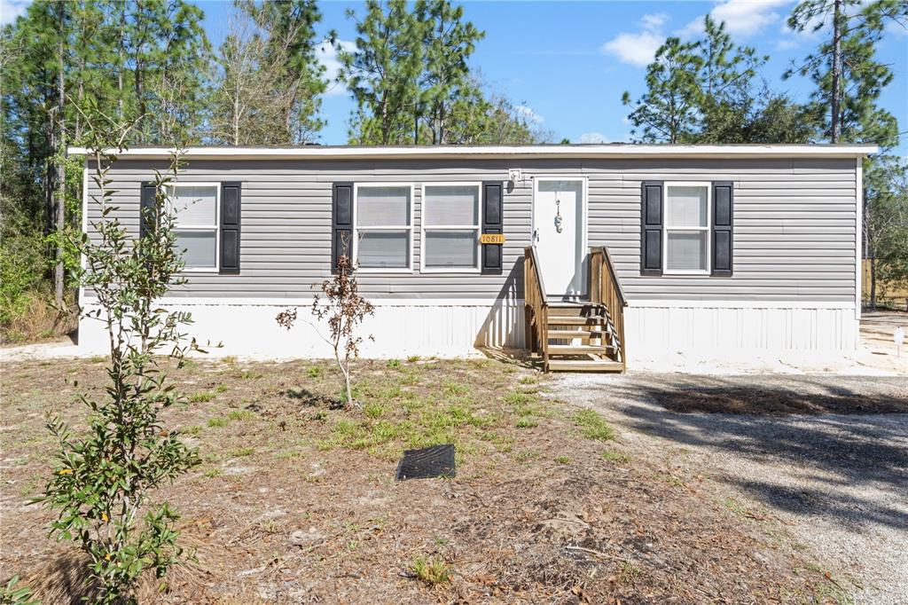 10811 Northeast 57th Street Bronson, FL 32621 - Photo 2 of 21 front view of a house with a yard