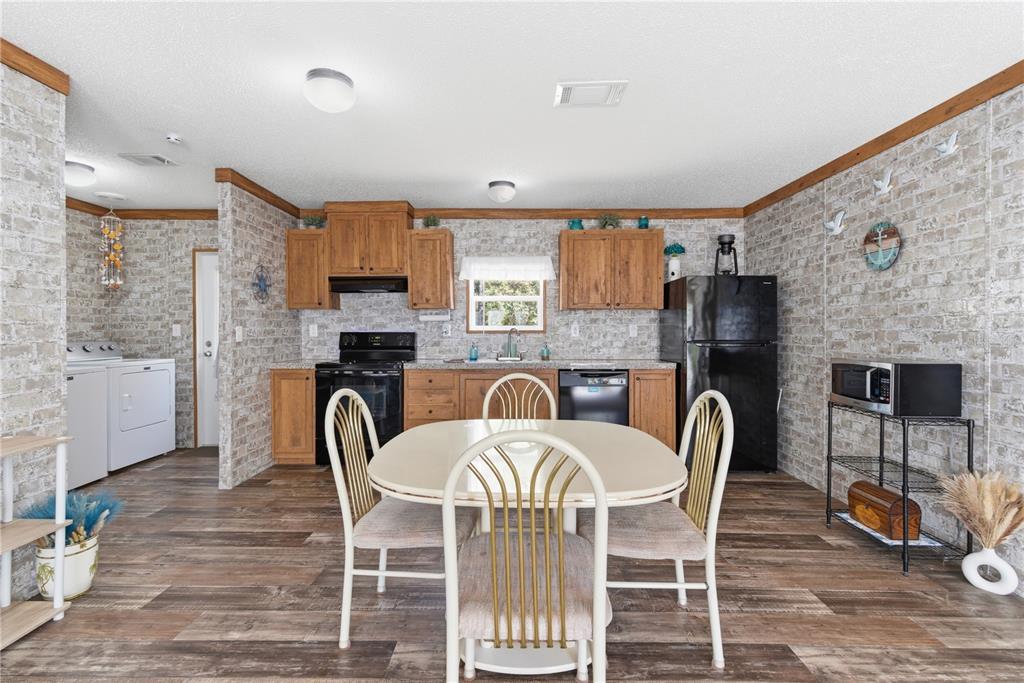 10811 Northeast 57th Street Bronson, FL 32621 - Photo 6 of 21 a view of a dining room with furniture window and wooden floor