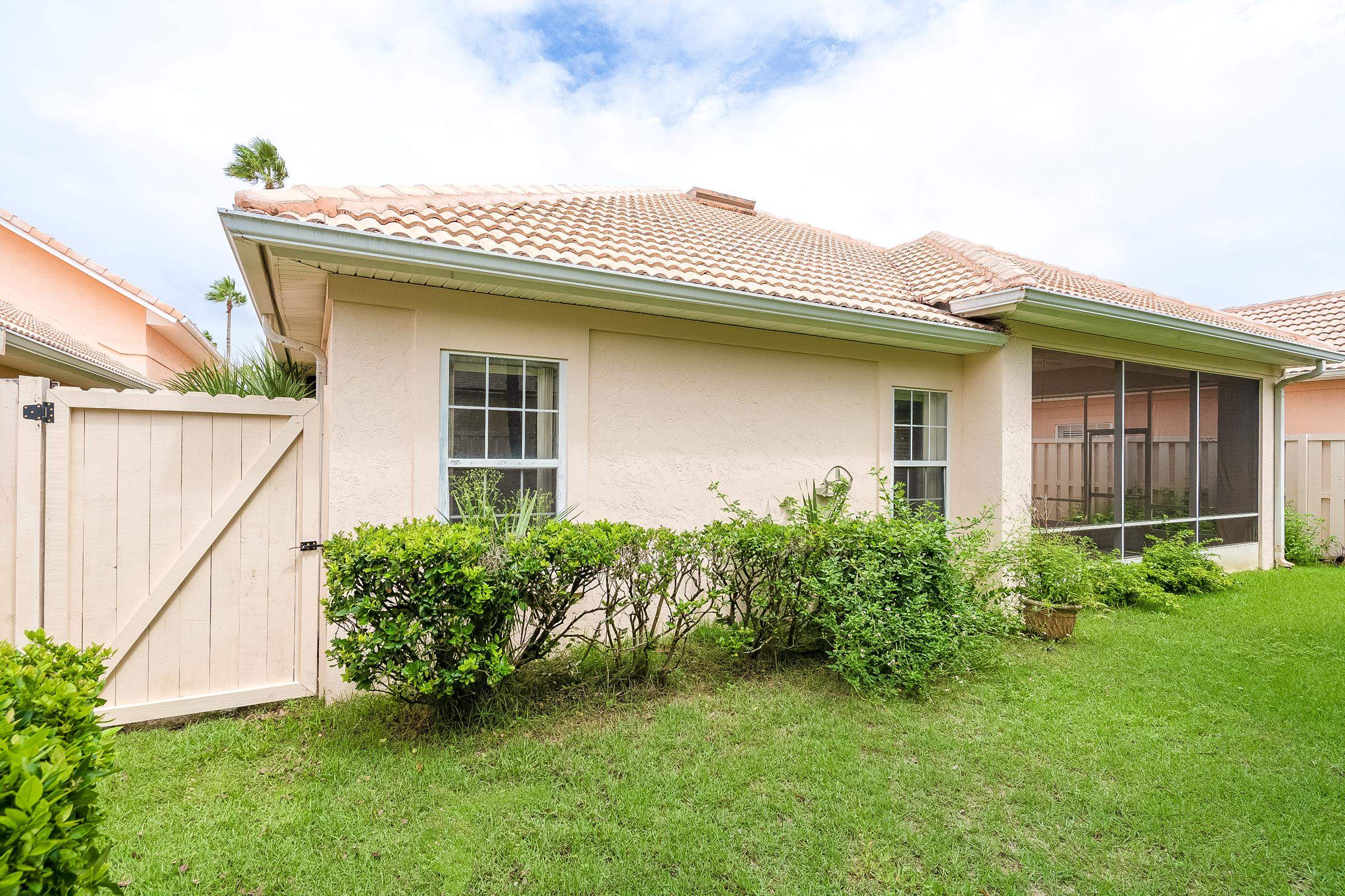 121 Tide Watch Drive St. Augustine, FL 32080 - Photo 21 of 49 a view of a house with brick walls and a yard with plants