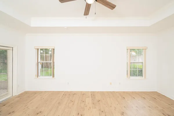 a view of a room with wooden floor