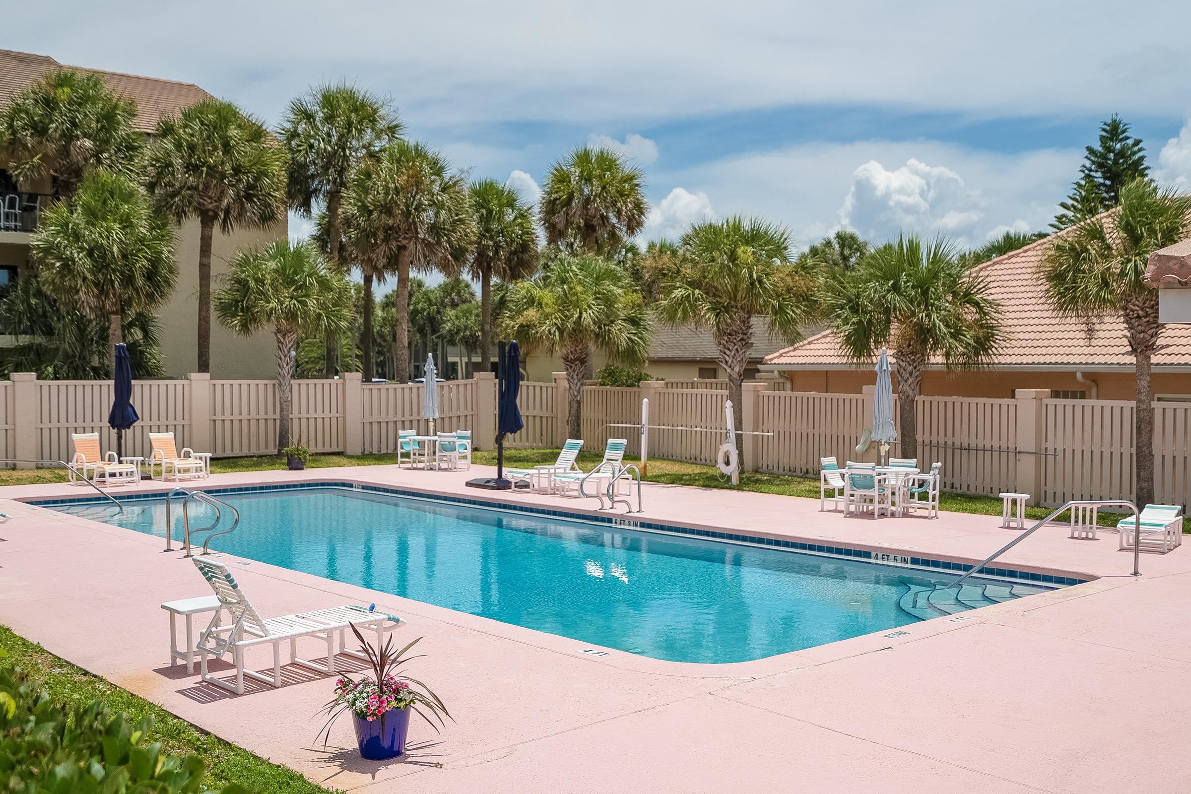 121 Tide Watch Drive St. Augustine, FL 32080 - Photo 44 of 49 a view of a swimming pool with a lounge chairs