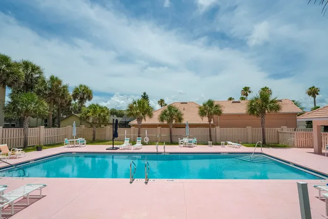 a swimming pool with outdoor seating yard and plants