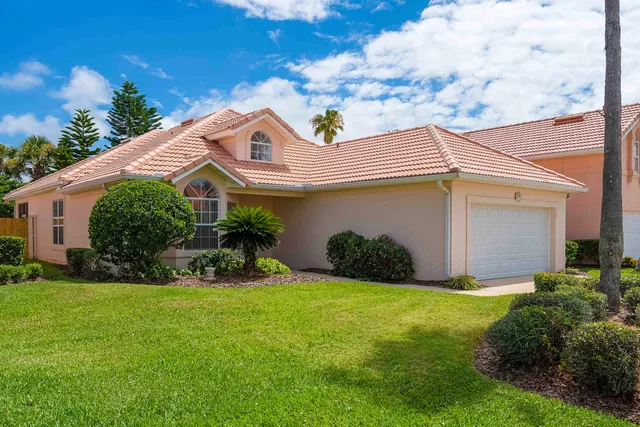 a front view of a house with garden and porch